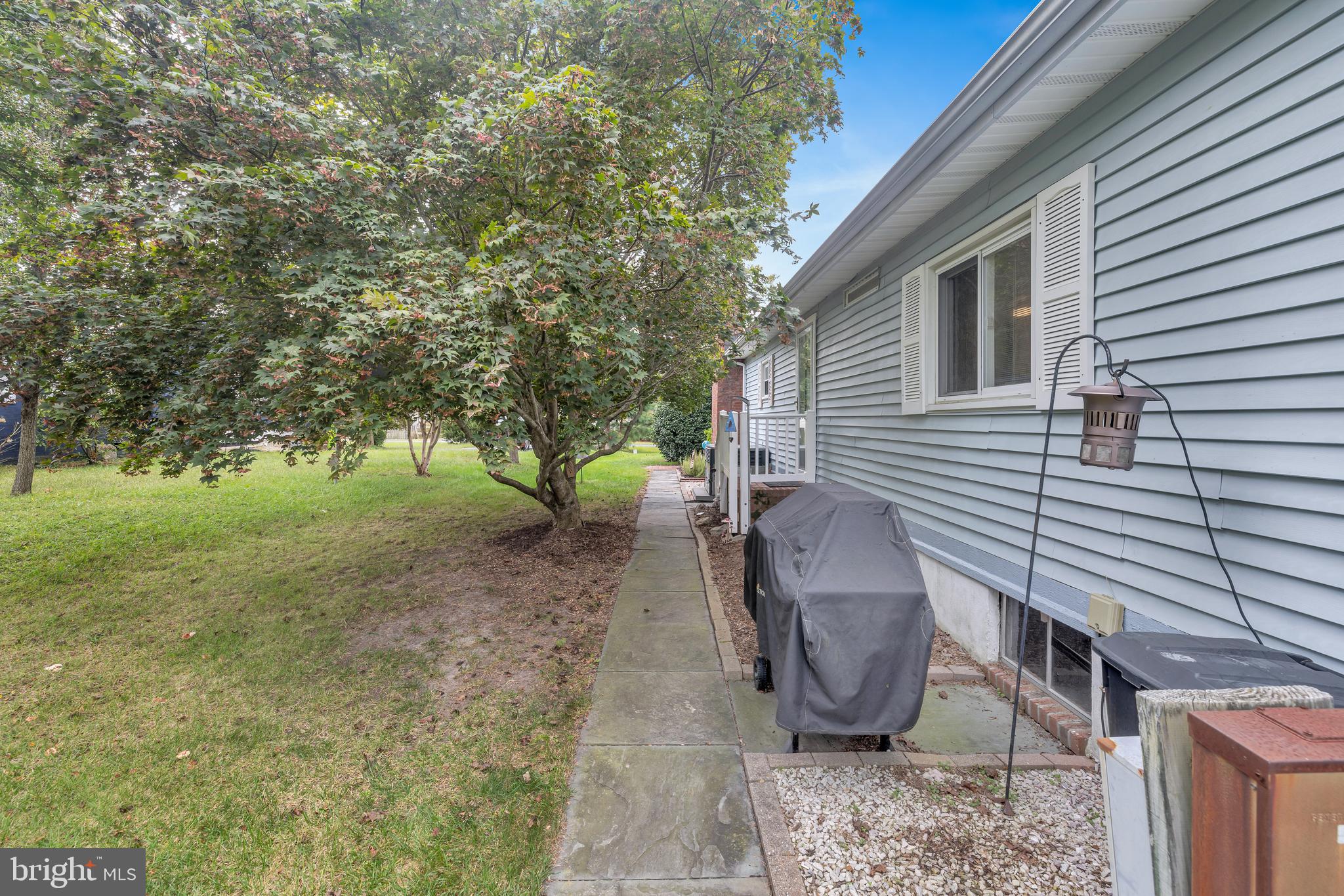 30879 Maplewood Road Ocean View, DE 19970 - Photo 35 of 41 a view of a backyard with table and chairs and a large tree