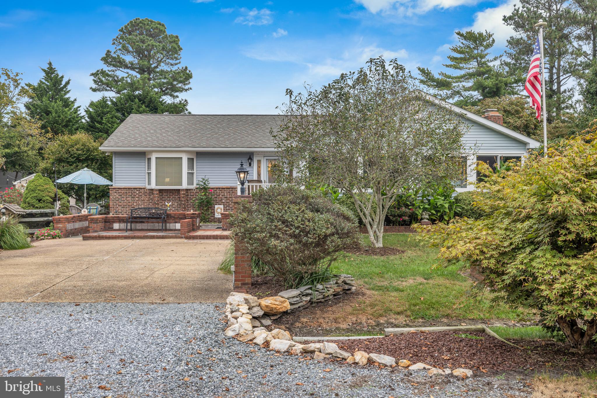 30879 Maplewood Road Ocean View, DE 19970 - Photo 4 of 41 a front view of a house with a yard and a garage