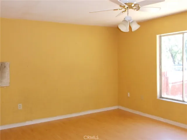 a view of a room with a window and a fan