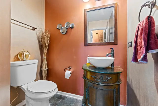 a bathroom with a toilet and a mirror