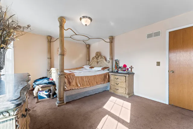 a bedroom with a bed and a dresser