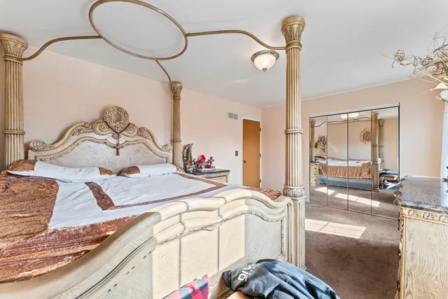 a bedroom with a bed and the mirror