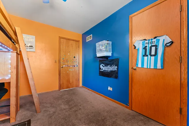 a view of a room with wooden floor and a window