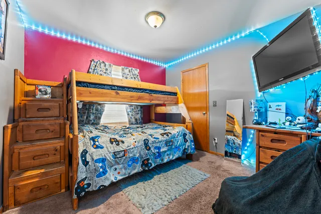 a bedroom with a bed and a tv