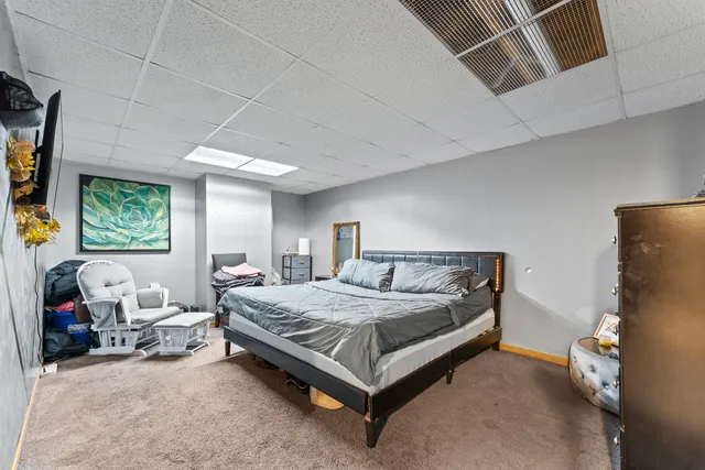 a bedroom with a bed couch and window