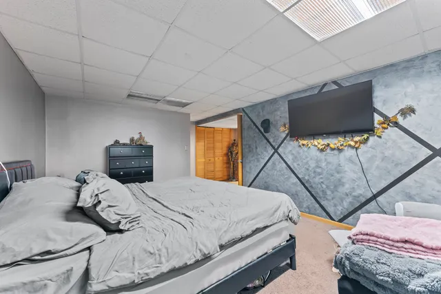 a bedroom with a bed and a couch