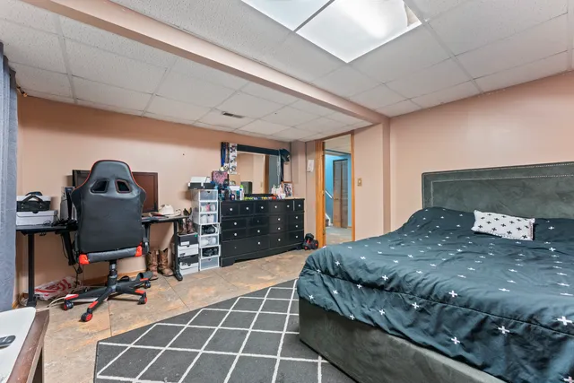 a bedroom with a bed and a desk