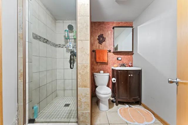 a bathroom with a toilet a sink and shower