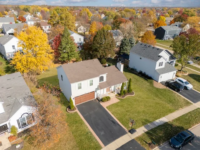 an aerial view of residential houses with outdoor space