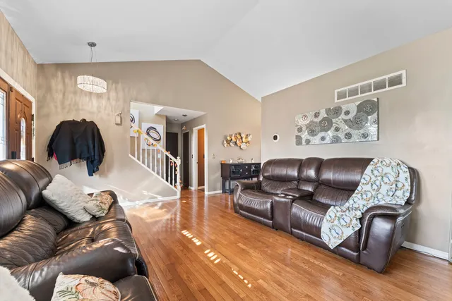 a living room with furniture and wooden floor