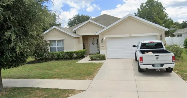 a car parked in front of white house