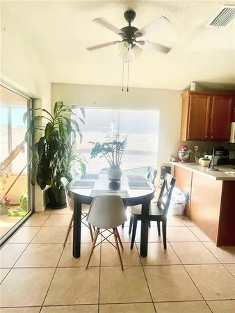a view of a dining room with furniture and chandelier