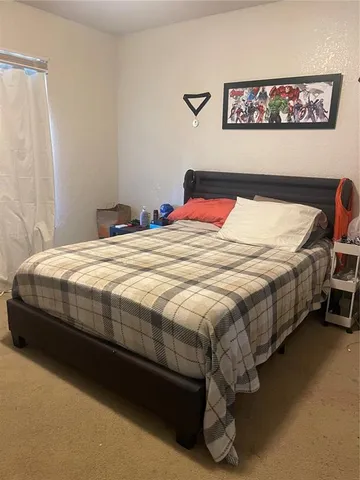 a bedroom with a bed and a desk