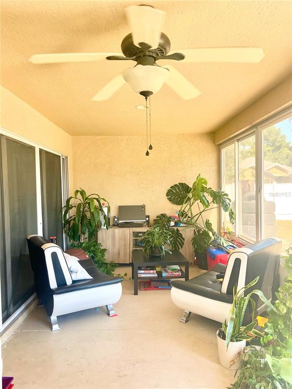 3921 Southwest 58th Avenue Ocala, FL 34474 - Photo 20 of 31 a living room with furniture and a floor to ceiling window