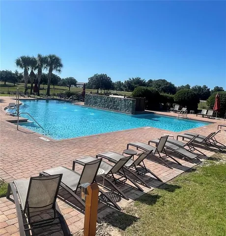 a view of a swimming pool with lounge chairs