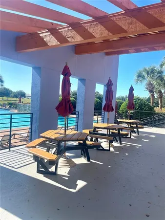 a view of a patio with a table and chairs under an umbrella