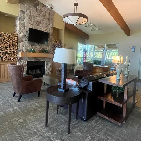 a living room with furniture a fireplace and a chandelier