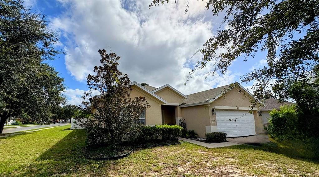 3921 Southwest 58th Avenue Ocala, FL 34474 - Photo 3 of 31 a view of a house with a yard and large trees