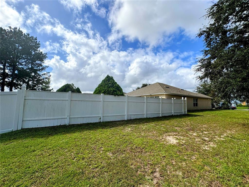 3921 Southwest 58th Avenue Ocala, FL 34474 - Photo 6 of 31 a view of a house with a yard and large trees