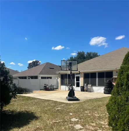 a front view of a house with a yard fountain and a tree