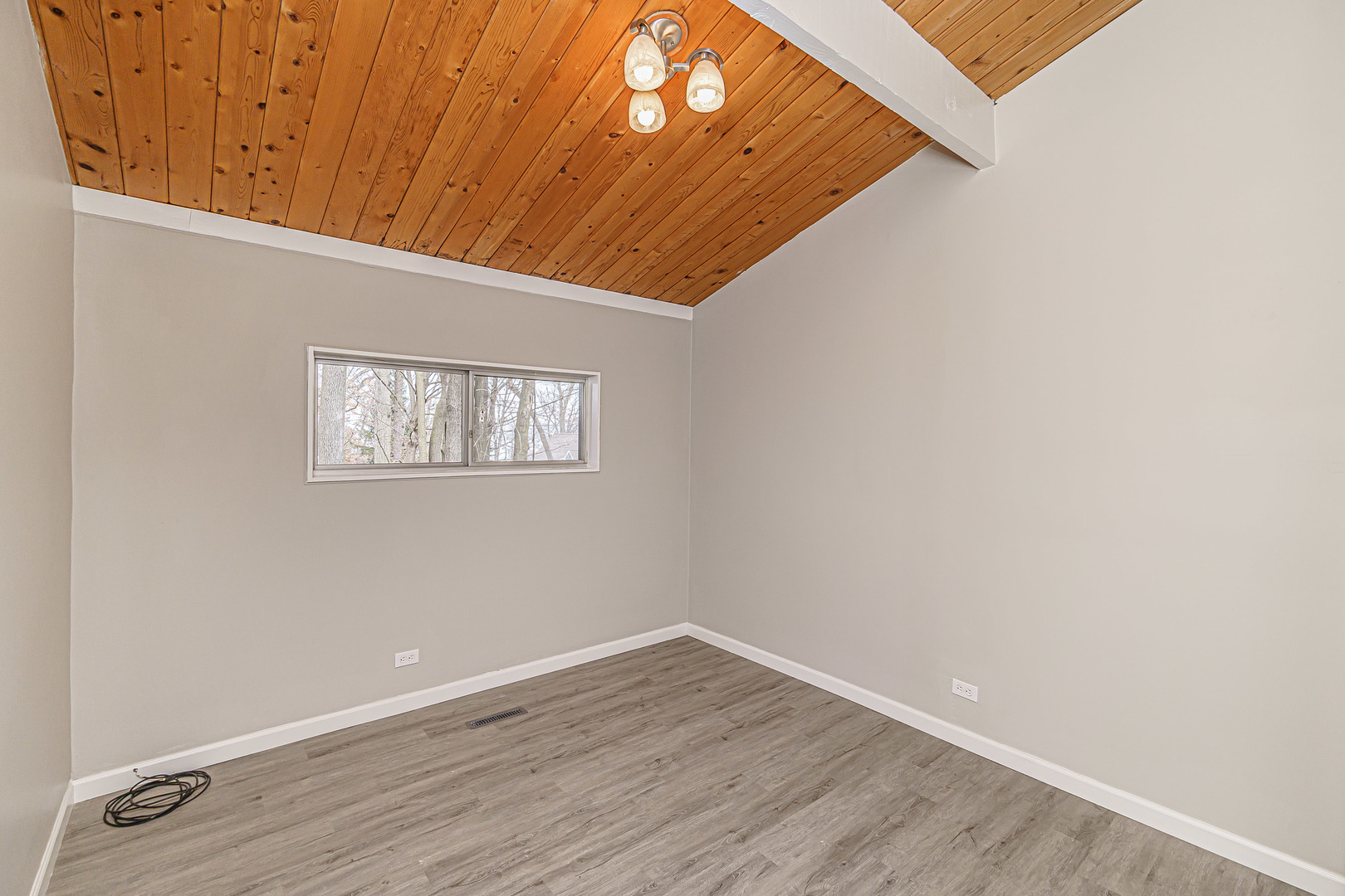 N1801 Birch Drive Linn, WI 53147 - Photo 14 of 33 a view of an empty room with wooden floor and a window