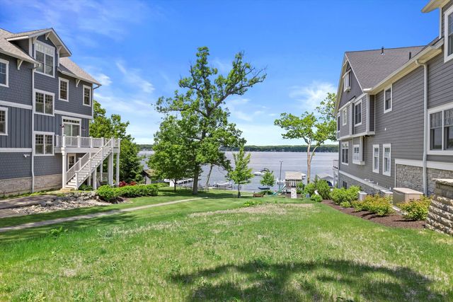 a view of a chair and table in backyard of the house
