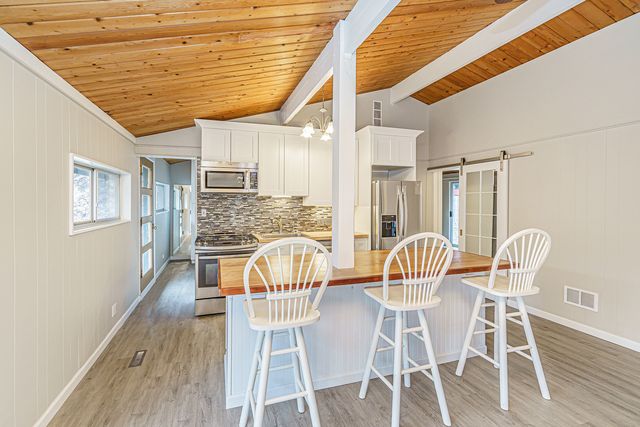 a dining room with furniture and wooden floor