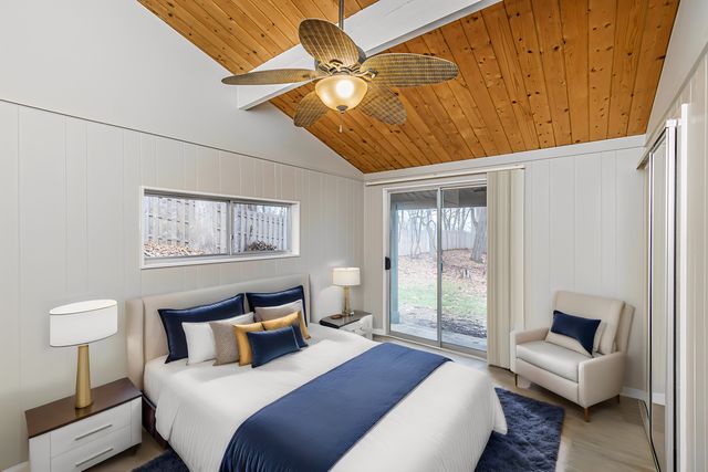 a bedroom with a bed a couch and a window