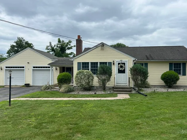 a front view of a house with a yard