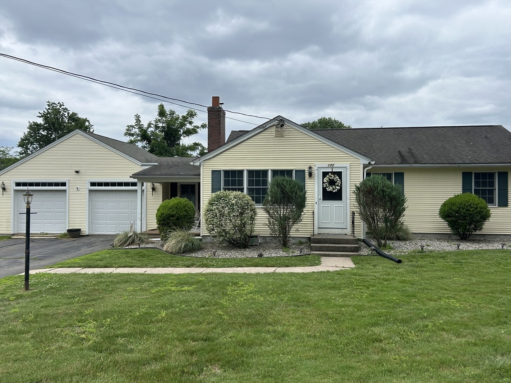 a front view of a house with a yard