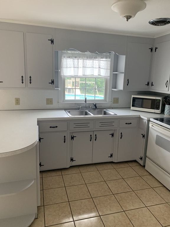 172 Maple Street East Longmeadow, MA 01028 - Photo 13 of 35 a kitchen with a sink stove and cabinets