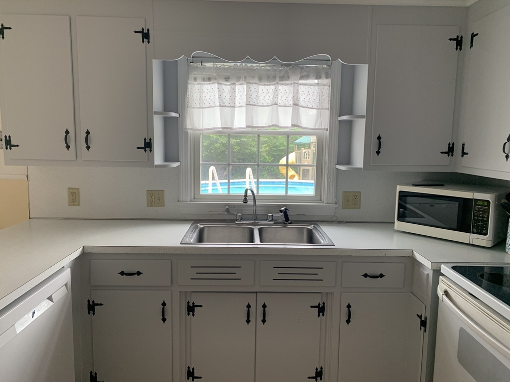 172 Maple Street East Longmeadow, MA 01028 - Photo 16 of 35 a kitchen with stainless steel appliances granite countertop a sink a stove and a microwave