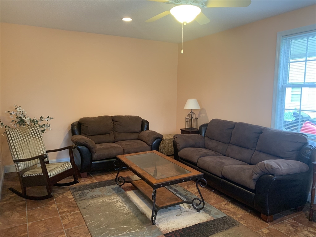 172 Maple Street East Longmeadow, MA 01028 - Photo 26 of 35 a living room with furniture a lamp and a potted plant