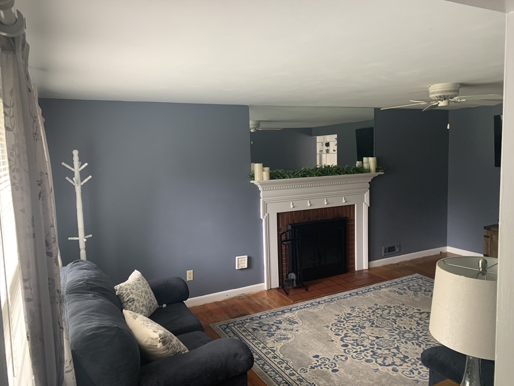 172 Maple Street East Longmeadow, MA 01028 - Photo 9 of 35 a living room with furniture a fireplace and a flat screen tv