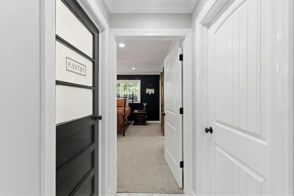 a view of a hallway with wooden shelves