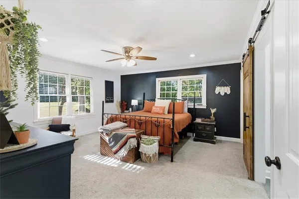 a bedroom with furniture and a window
