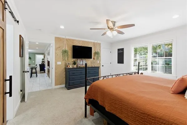 a bedroom with a bed and a flat screen tv