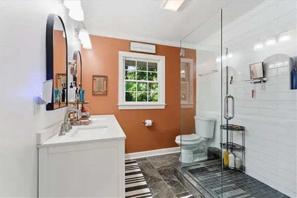 a bathroom with a sink toilet and shower