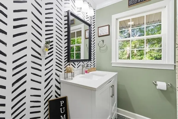 a bathroom with a sink a mirror and a window