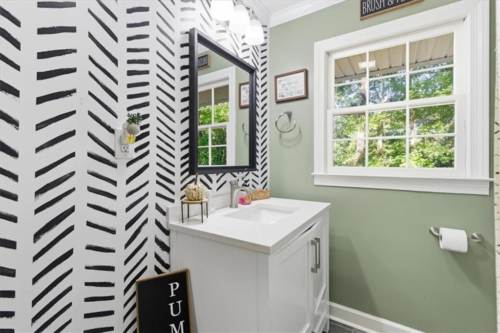 7 Thrushwood Road Northeast Rome, GA 30161 - Photo 19 of 37 a bathroom with a sink a mirror and a window