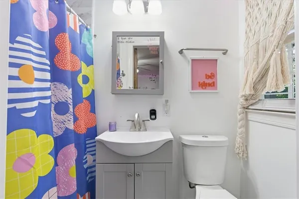 a bathroom with a sink toilet and mirror