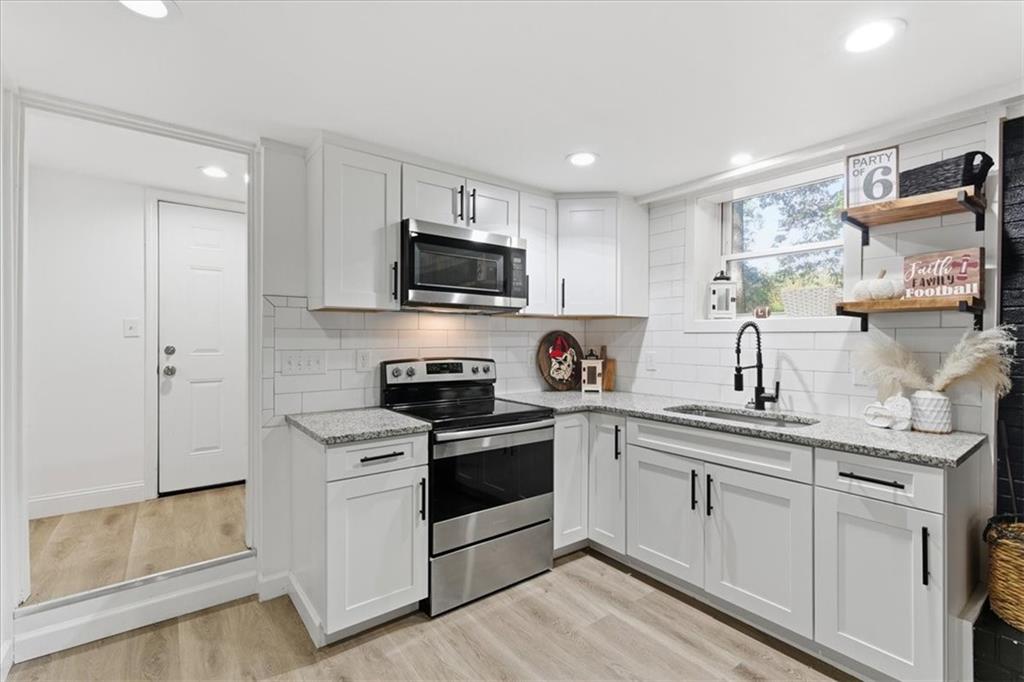 7 Thrushwood Road Northeast Rome, GA 30161 - Photo 30 of 37 a kitchen with white cabinets stainless steel appliances and sink