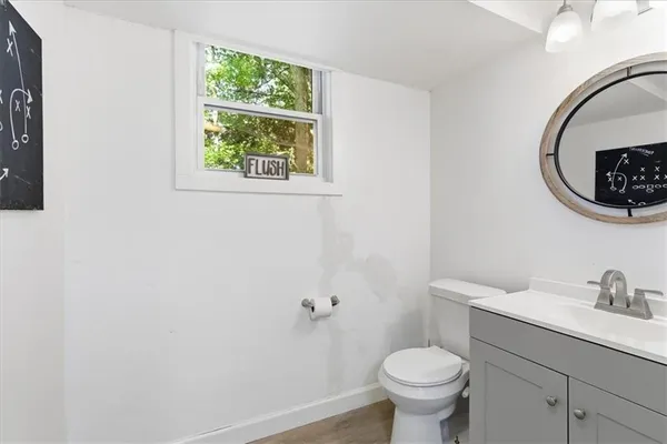 a bathroom with a toilet a sink and a window