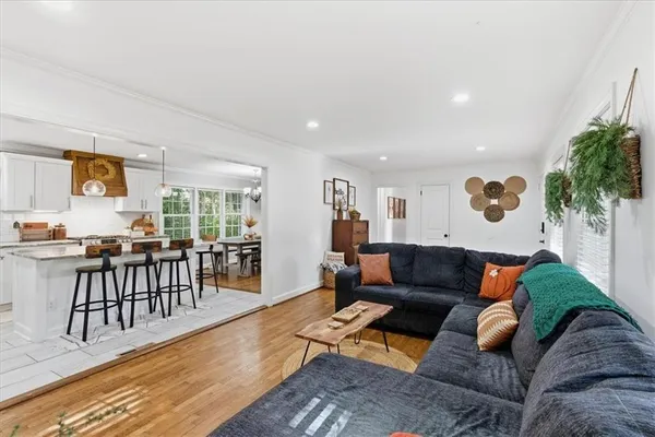 a living room with furniture and wooden floor