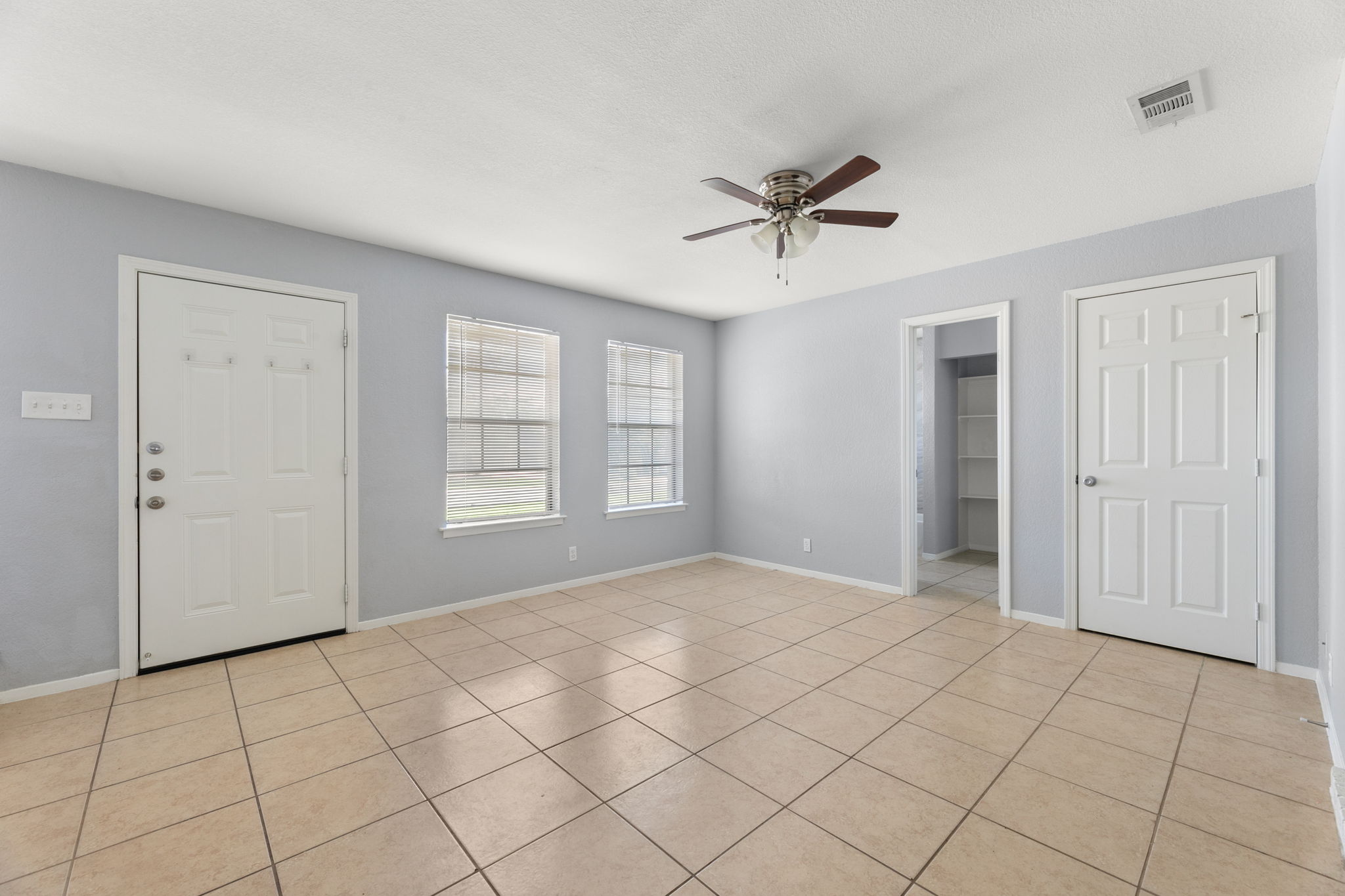 3802 Foust Trail, Unit A Georgetown, TX 78628 - Photo 4 of 34 A versatile interior space featuring tiled floors and a refreshing ceiling fan.