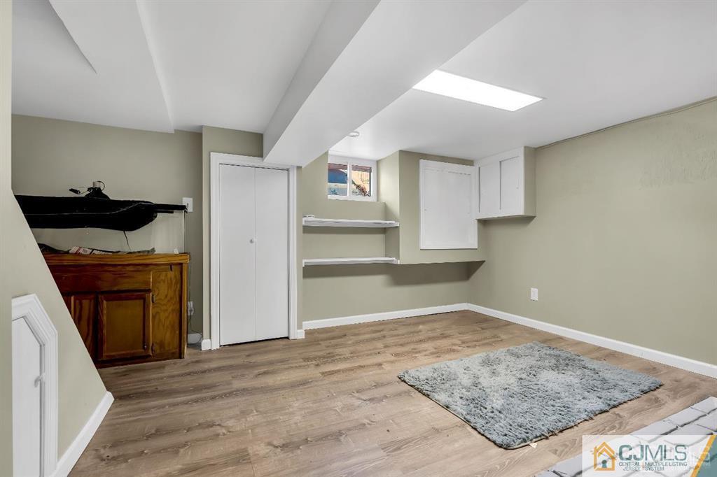 7 Downing Street Newark, NJ 07105 - Photo 11 of 18 a view of empty room with wooden floor and kitchen