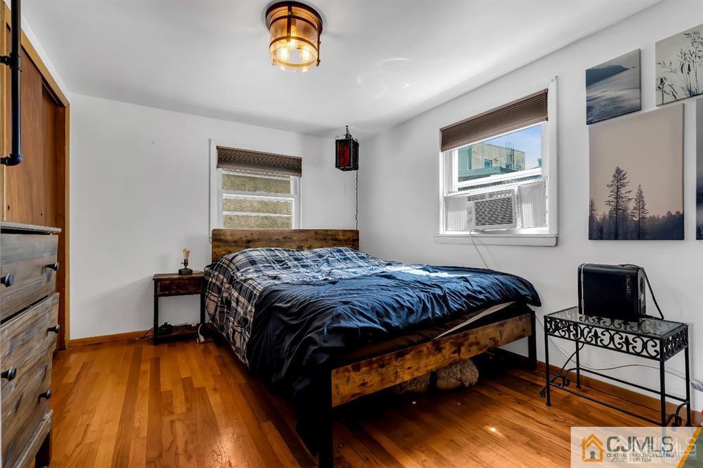 7 Downing Street Newark, NJ 07105 - Photo 13 of 18 a bedroom with a bed and a window