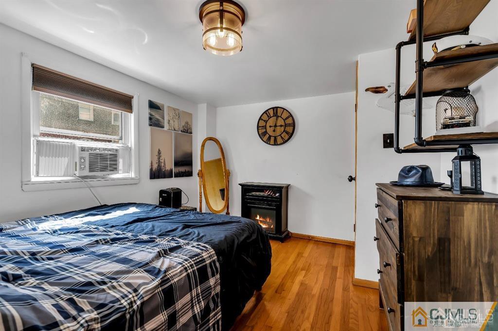 7 Downing Street Newark, NJ 07105 - Photo 14 of 18 a bedroom with a bed and wooden floor
