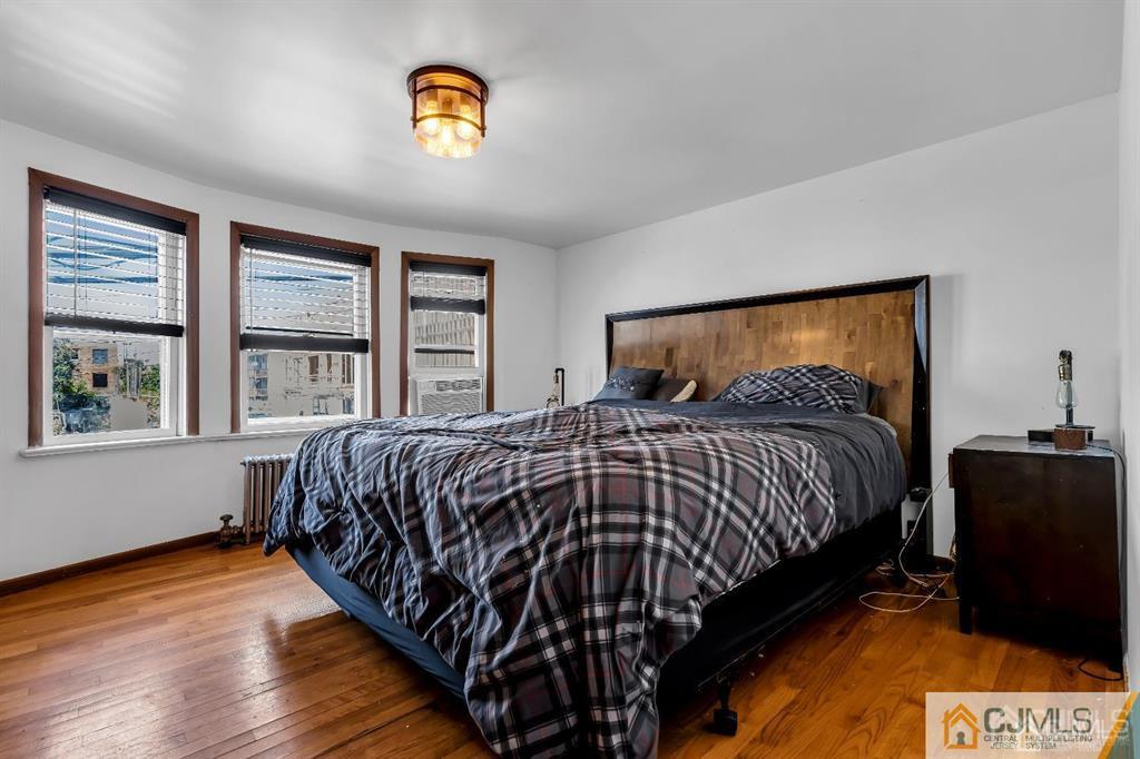7 Downing Street Newark, NJ 07105 - Photo 15 of 18 a bedroom with a bed and a window