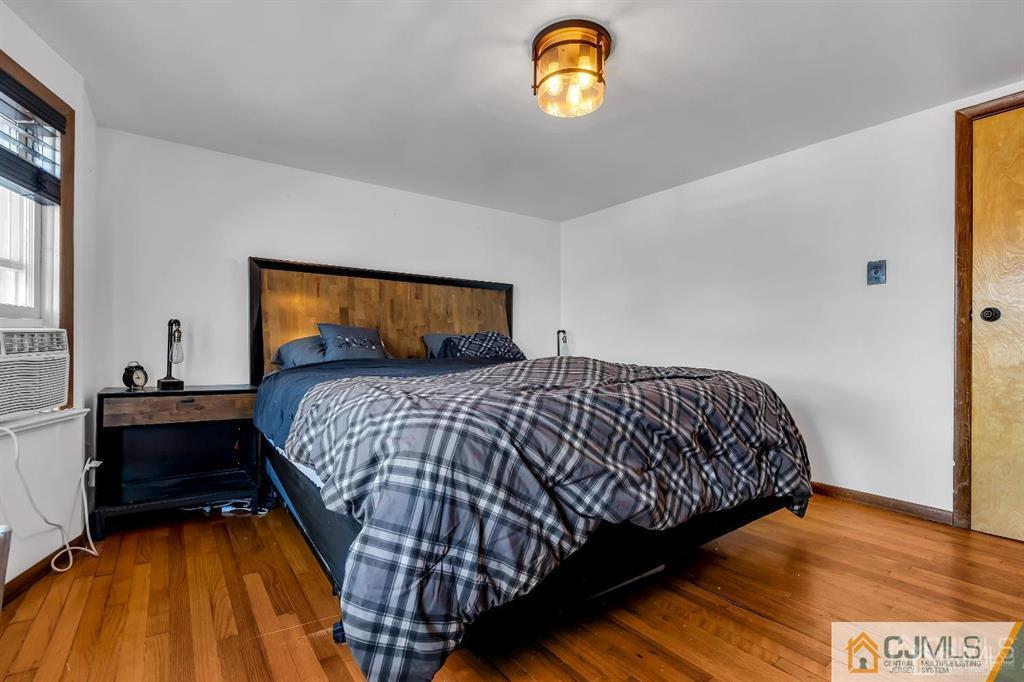 7 Downing Street Newark, NJ 07105 - Photo 16 of 18 a bedroom with a bed and a window